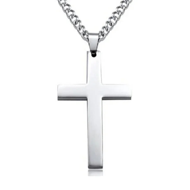 Silver cross pendant necklace with curb chain on white background