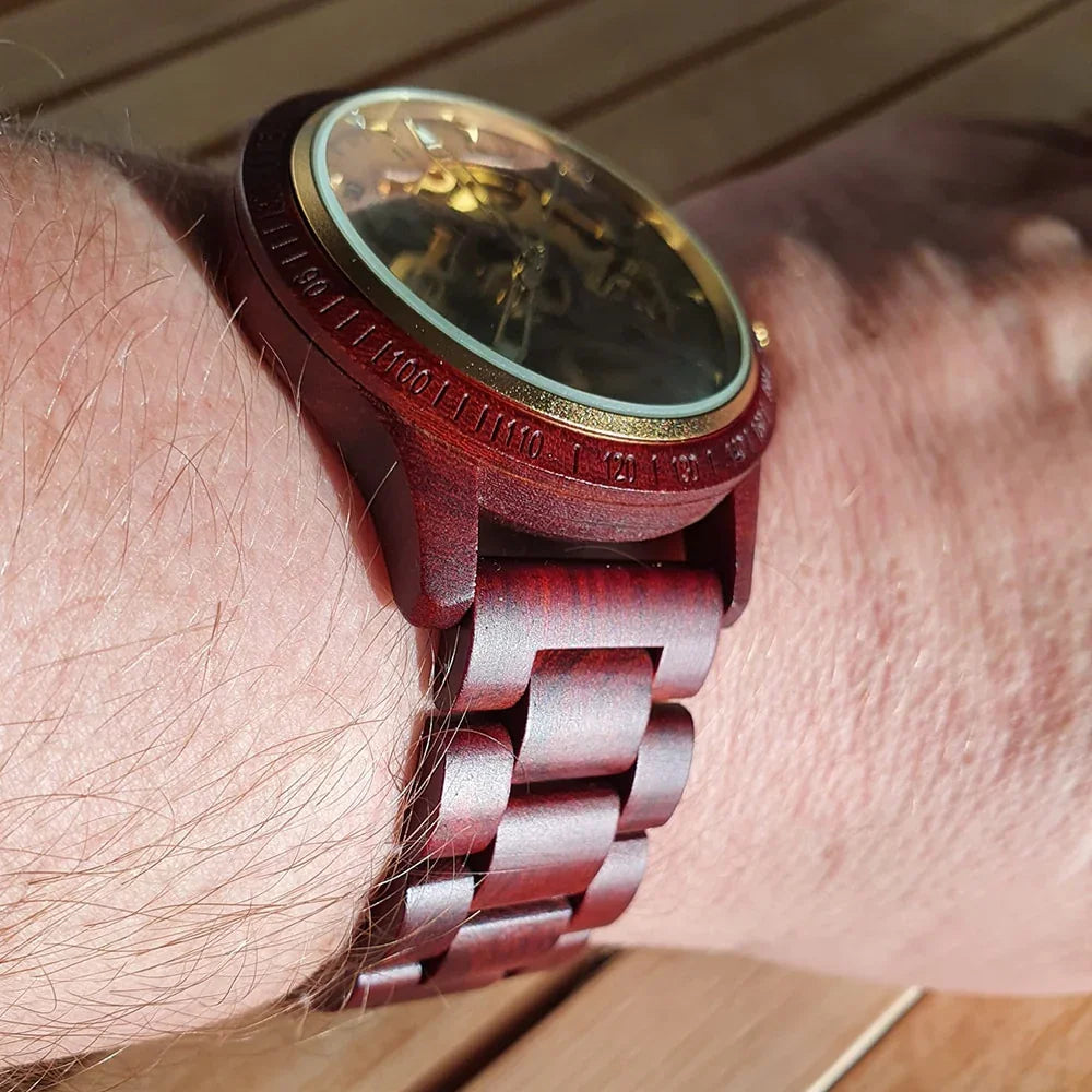 Men's wooden bracelet with dark wood links worn on wrist, natural light, close-up view