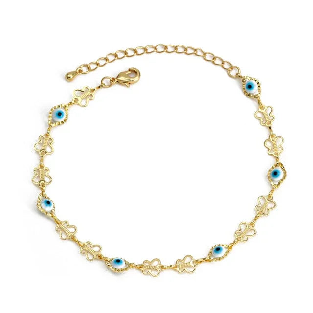Gold chain bracelet with blue evil eye charms and butterfly-shaped links on white background